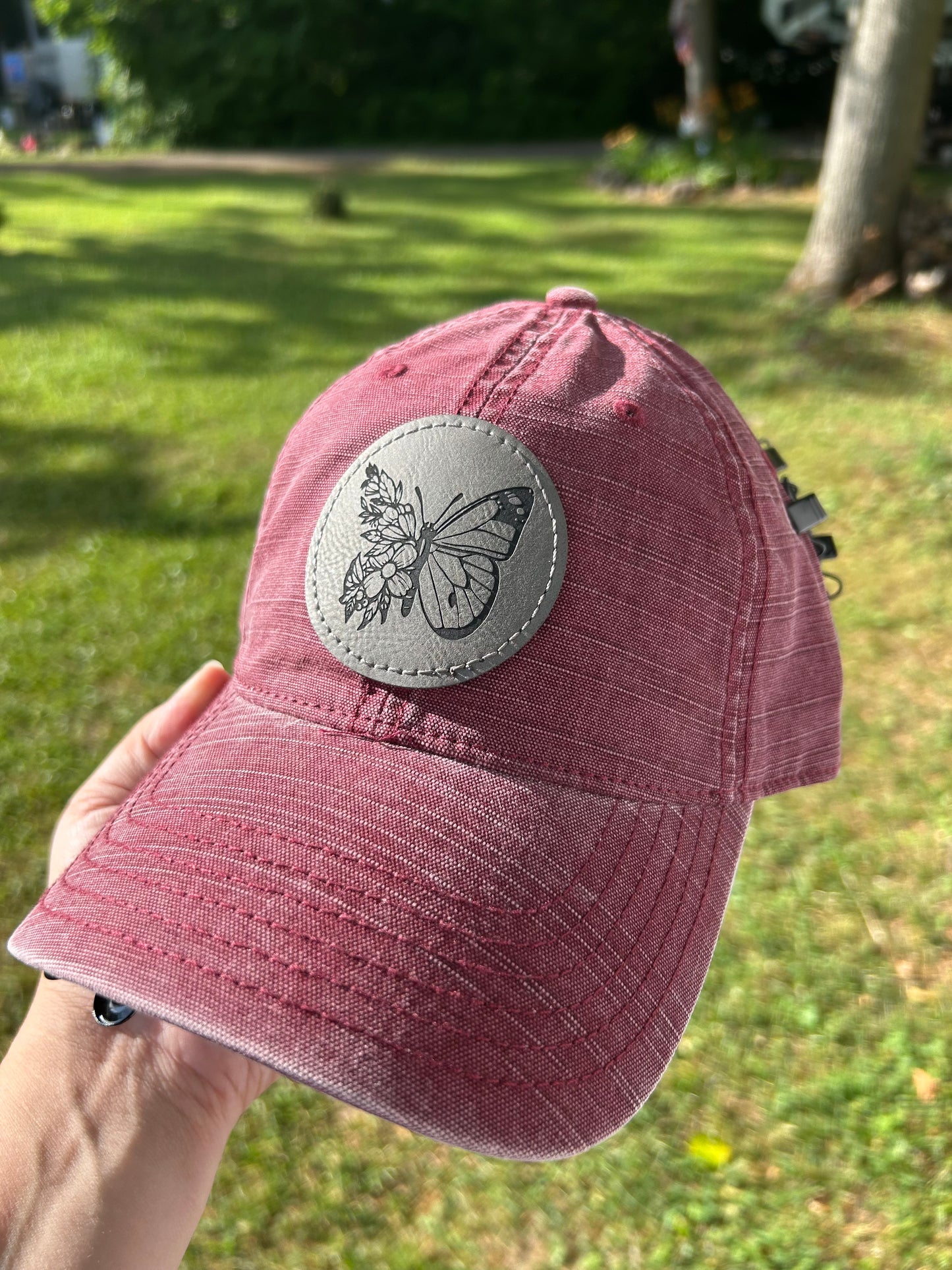 Maroon hat with grey butterfly patch