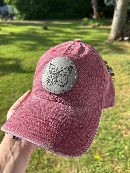 Maroon hat with grey butterfly patch